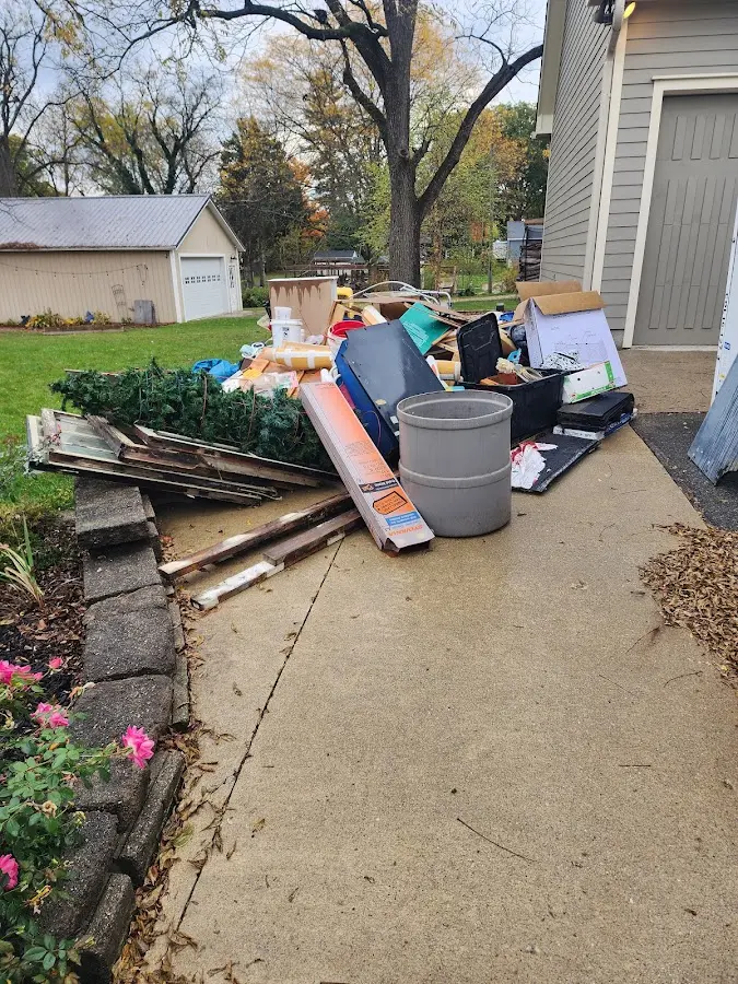 Dumpster being loaded with debris for Commercial Dumpster Rental in Burlington